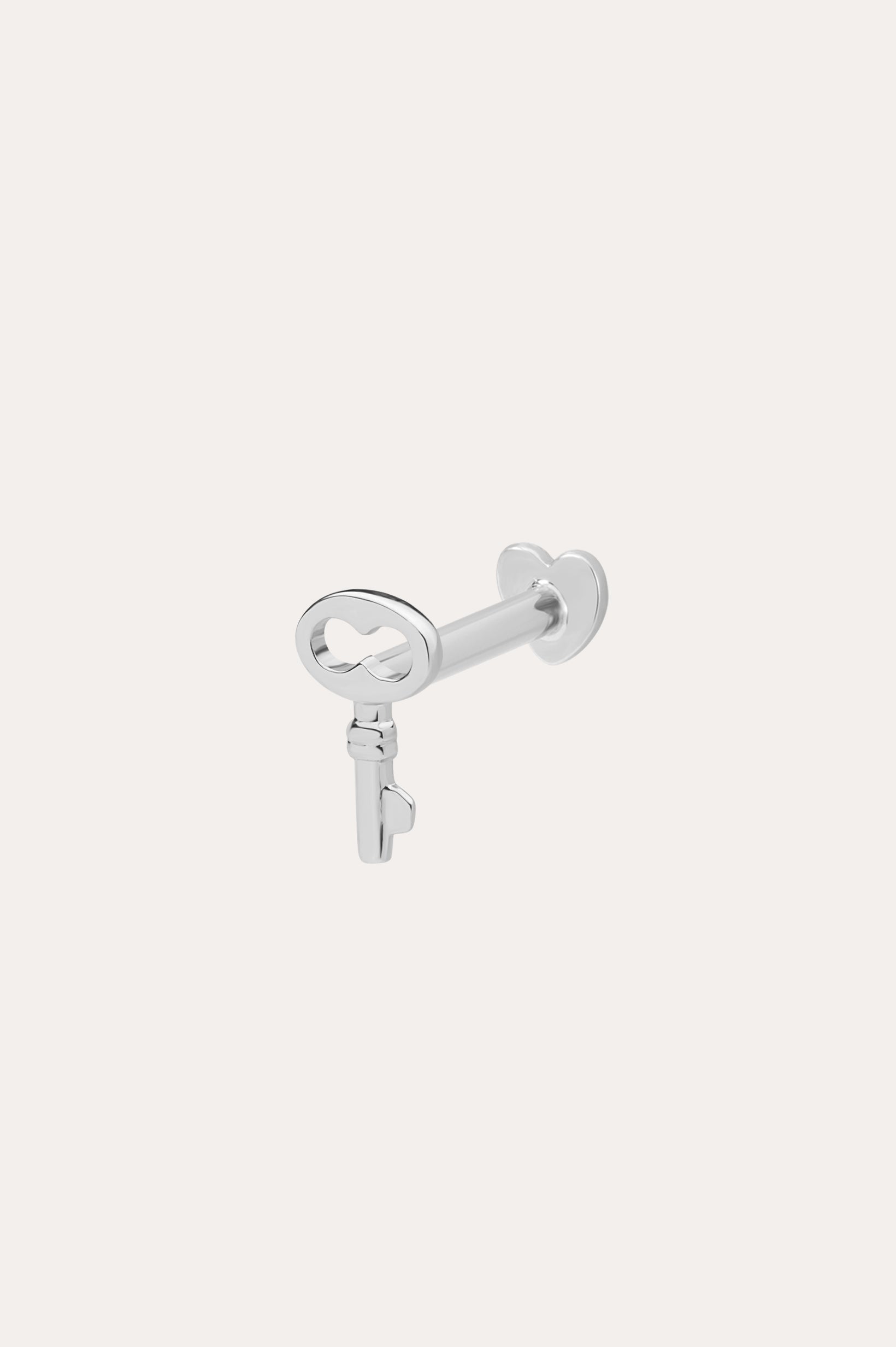 The 14K Solid White Gold Key Flat Back Stud, crafted in 14K white gold, is shown against a light background—ideal as a chic cartilage earring.