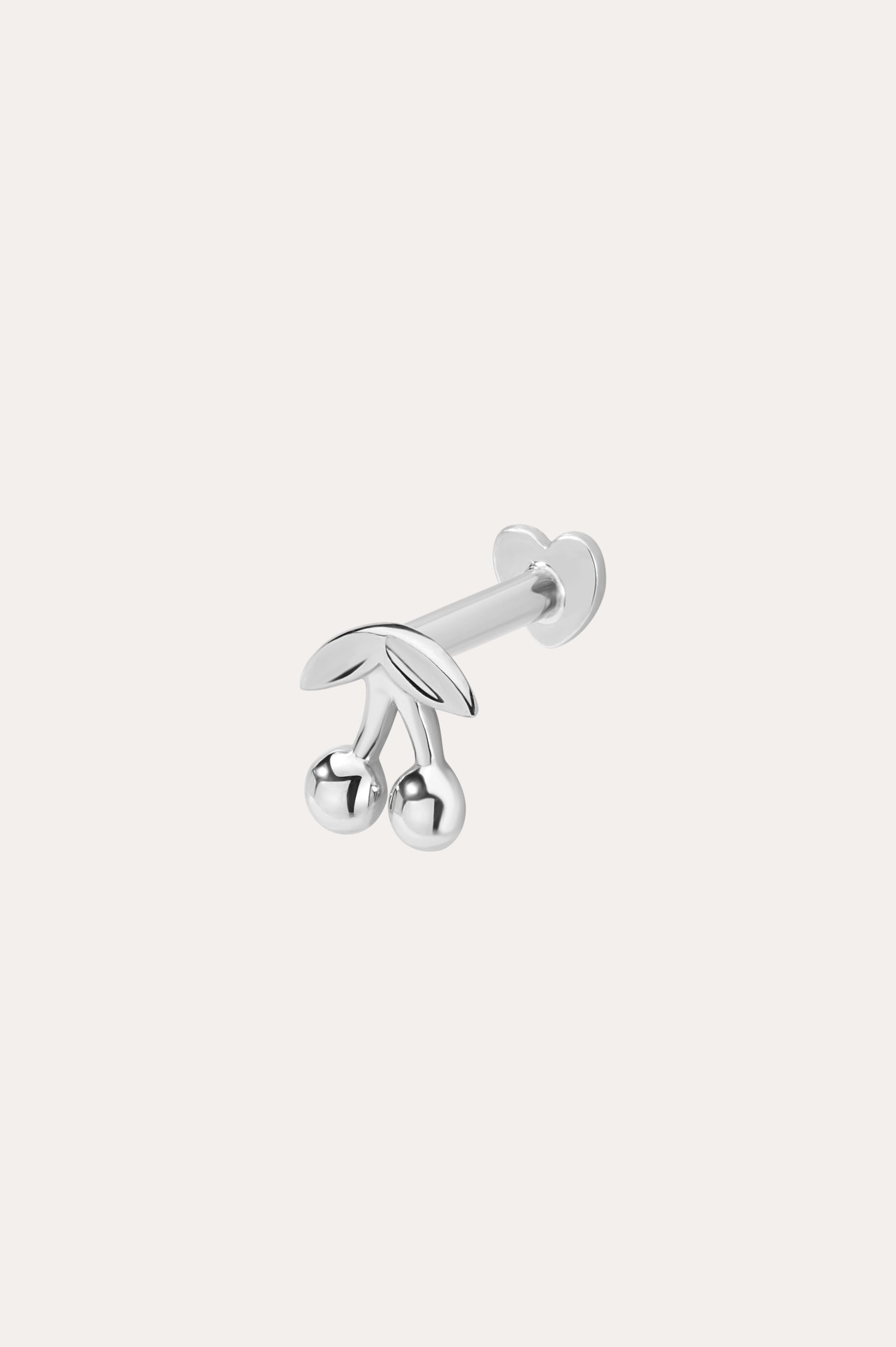 The 14K Solid White Gold Cherry Flat Back Stud, featuring two round cherry fruits and delicate leaves, stands out as elegant body jewelry against a plain light background.