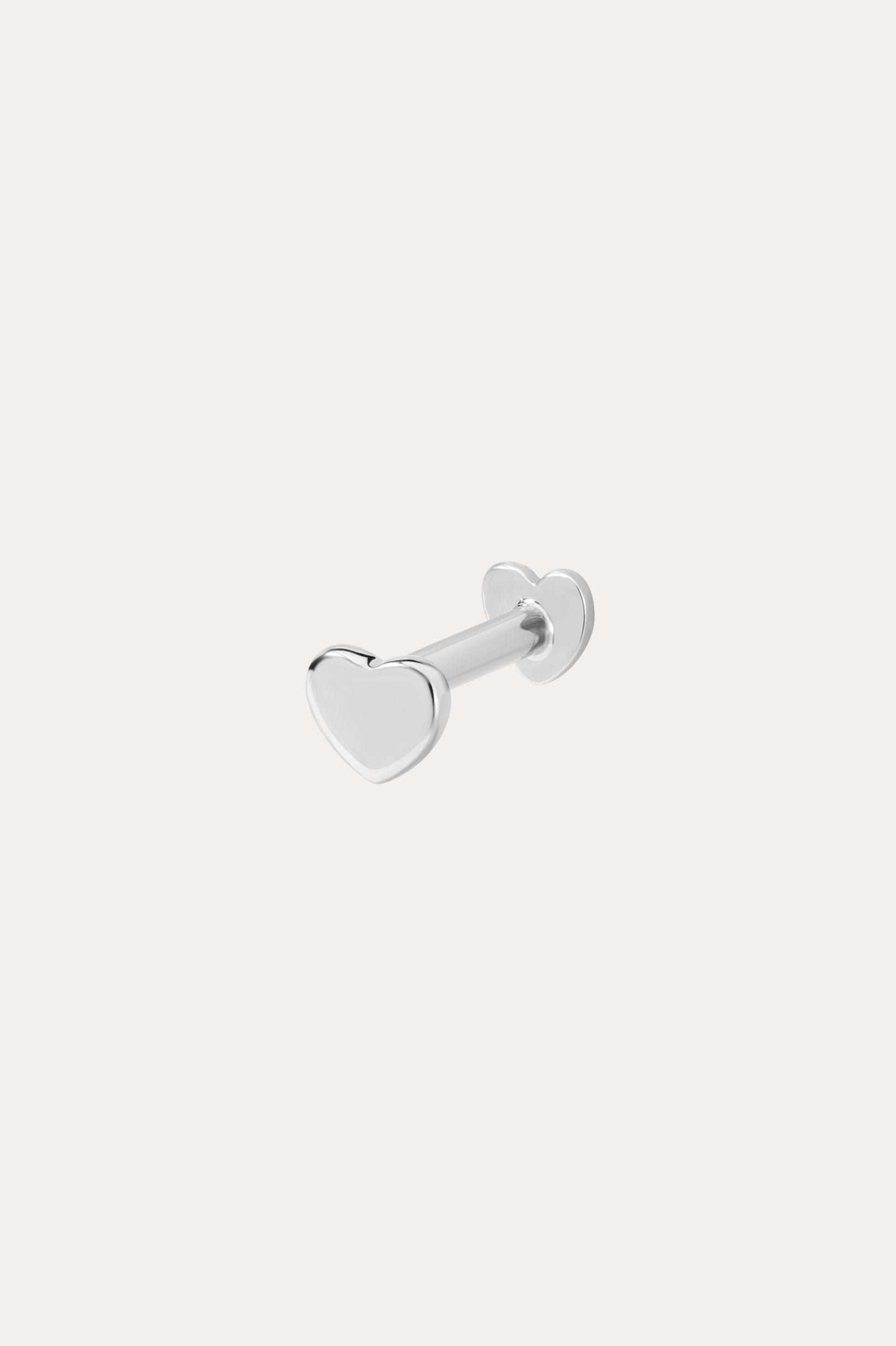 The 14K Solid White Gold Heart Flat Back Stud features a heart-shaped front and matching back, crafted in 14K white gold. Perfect as subtle body jewelry, its displayed on a plain white background.