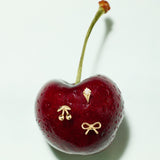 The 14K Solid Yellow Gold Cherry Flat Back Stud features a single cherry with three small 14k gold stud pins—a cherry, an ice cream cone, and a bow—set on a plain white background.
