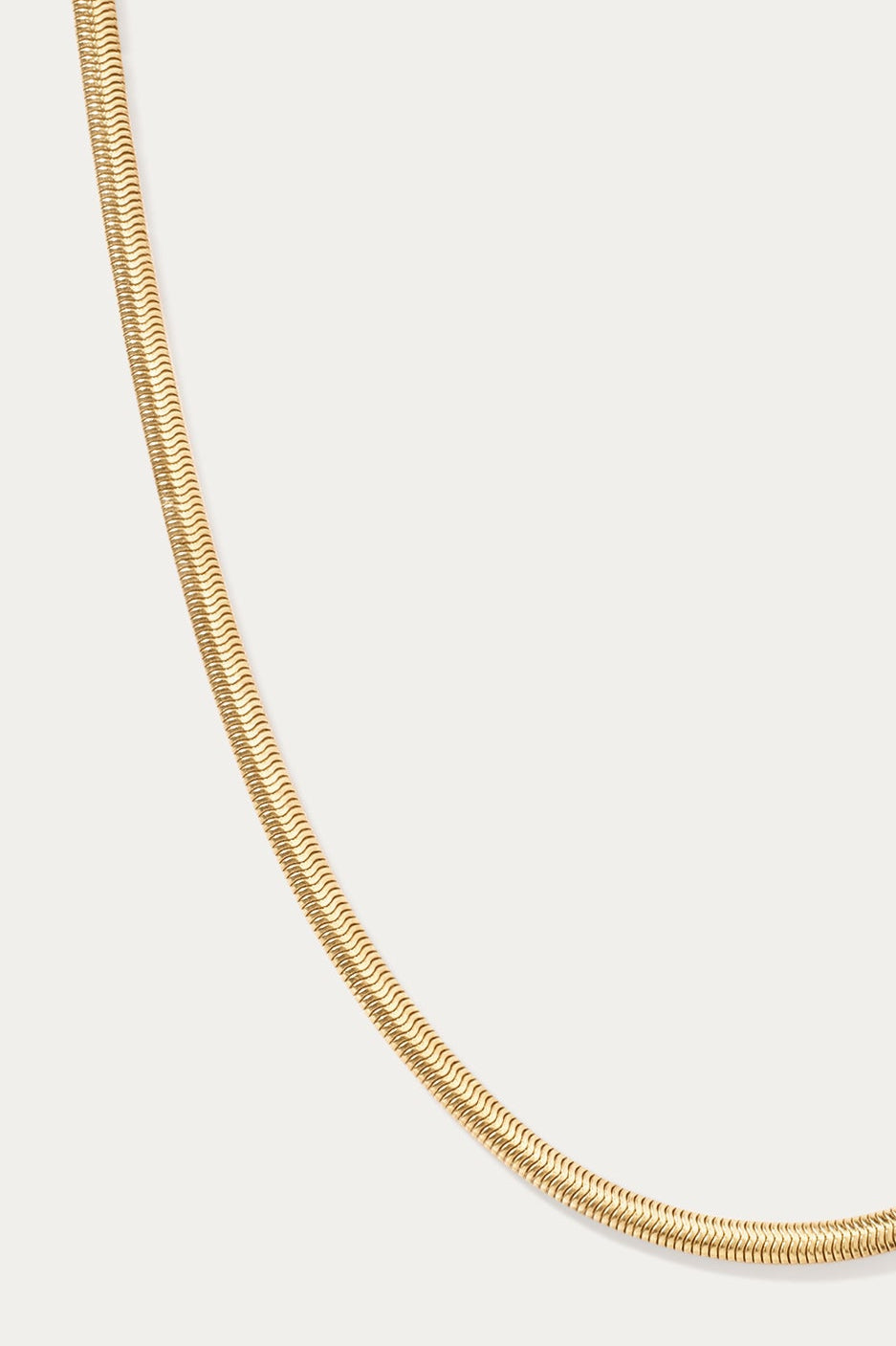 The Estelle Herringbone Chain Necklace in Gold is displayed against a plain white background, featuring a sleek 3mm chain for timeless elegance.