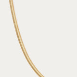 The Estelle Herringbone Chain Necklace in Gold is displayed against a plain white background, featuring a sleek 3mm chain for timeless elegance.