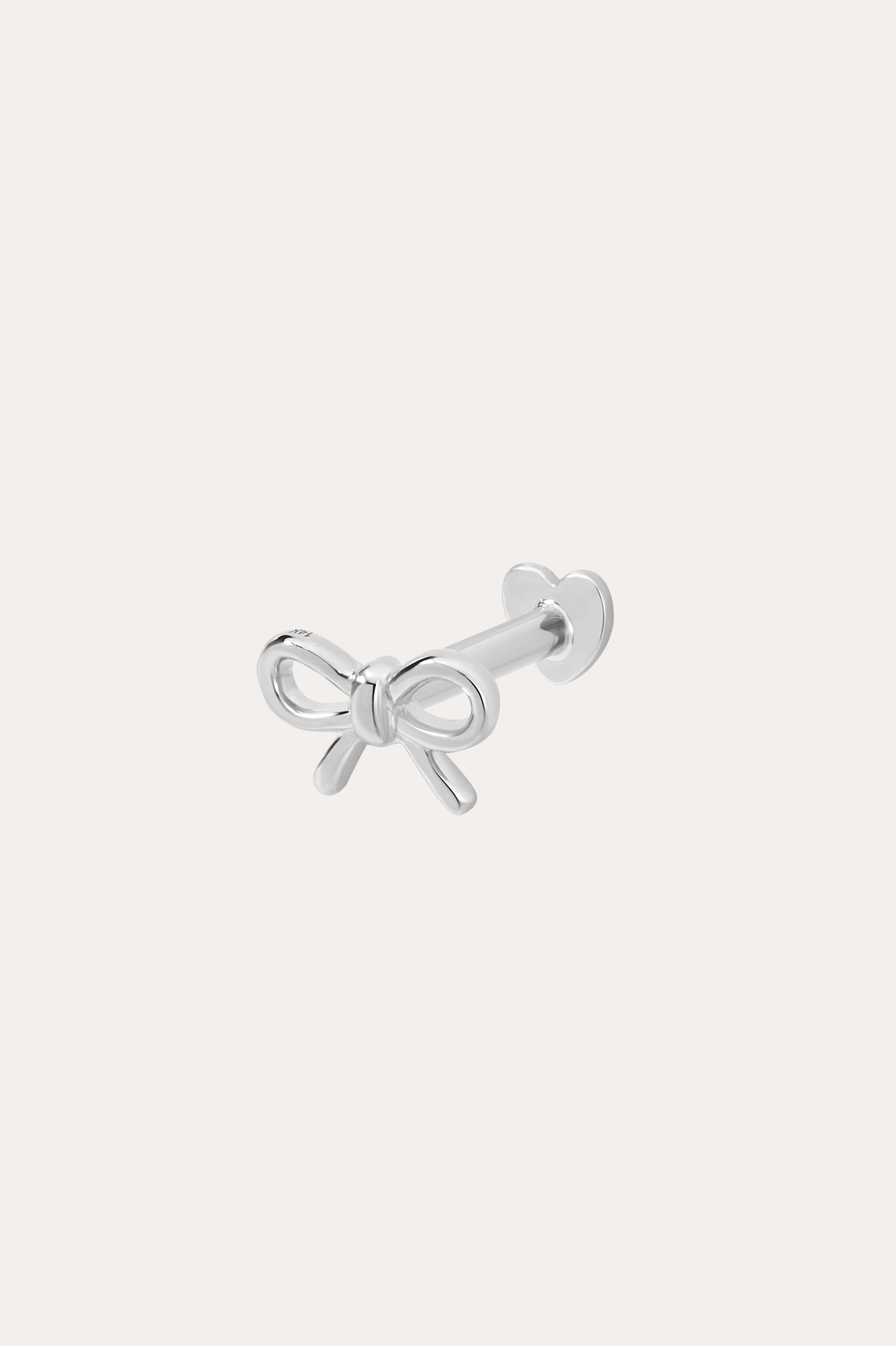 The 14K Solid White Gold Bow Tie Flat Back Stud, in 14K white gold, features a delicate bow front and heart-shaped flat back, shown on a plain white background.
