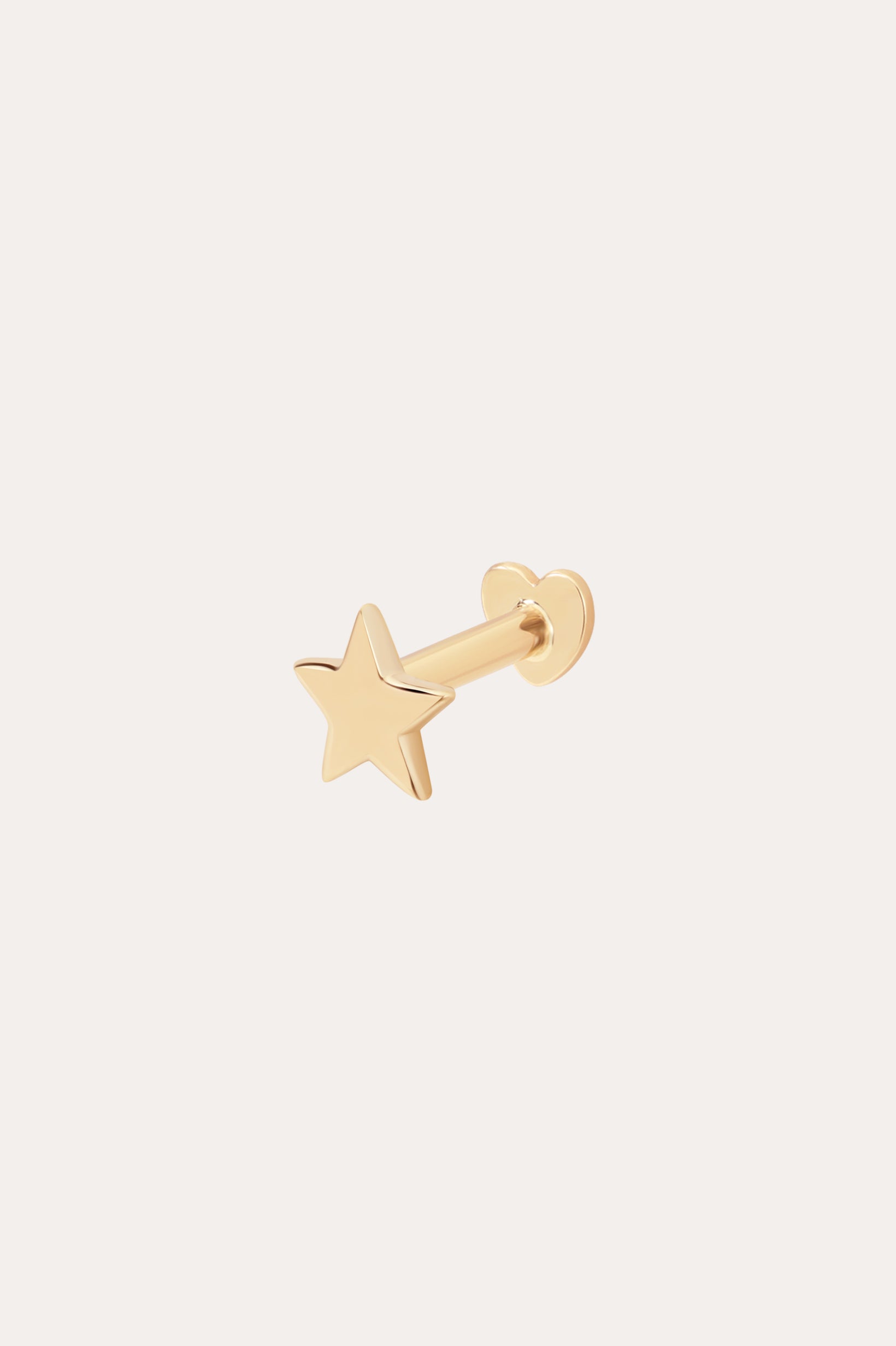 The 14K Solid Yellow Gold Star Flat Back Stud features a five-pointed star design in gleaming 14K yellow gold, making it a striking celestial ear accessory against any plain, light background.