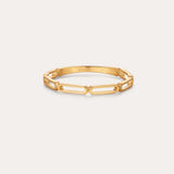 The Aisha Paperclip Stacking Ring in Gold features a delicate, open geometric link design—ideal as a dainty stacking ring and displayed on a simple, light background.