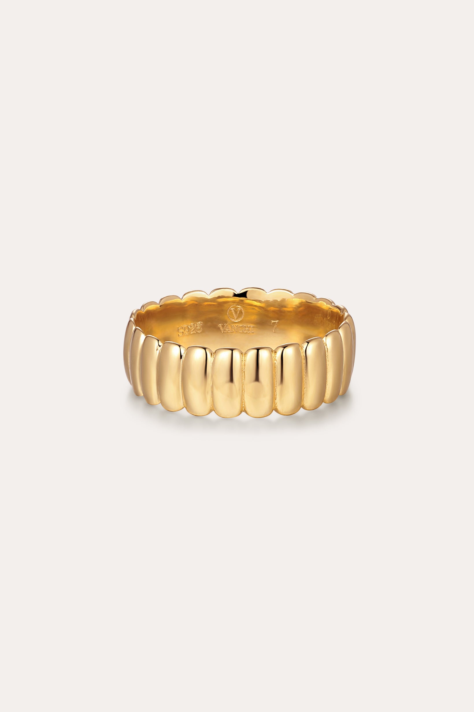 The Charlotte Eternity Ridged Ring in Gold features a scalloped, ribbed design encircling the band, elegantly displayed against a plain, light background.
