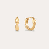 The Colette Droop Link Huggie Earrings in Gold feature smooth, rounded organic curves, showcased against a plain light background.
