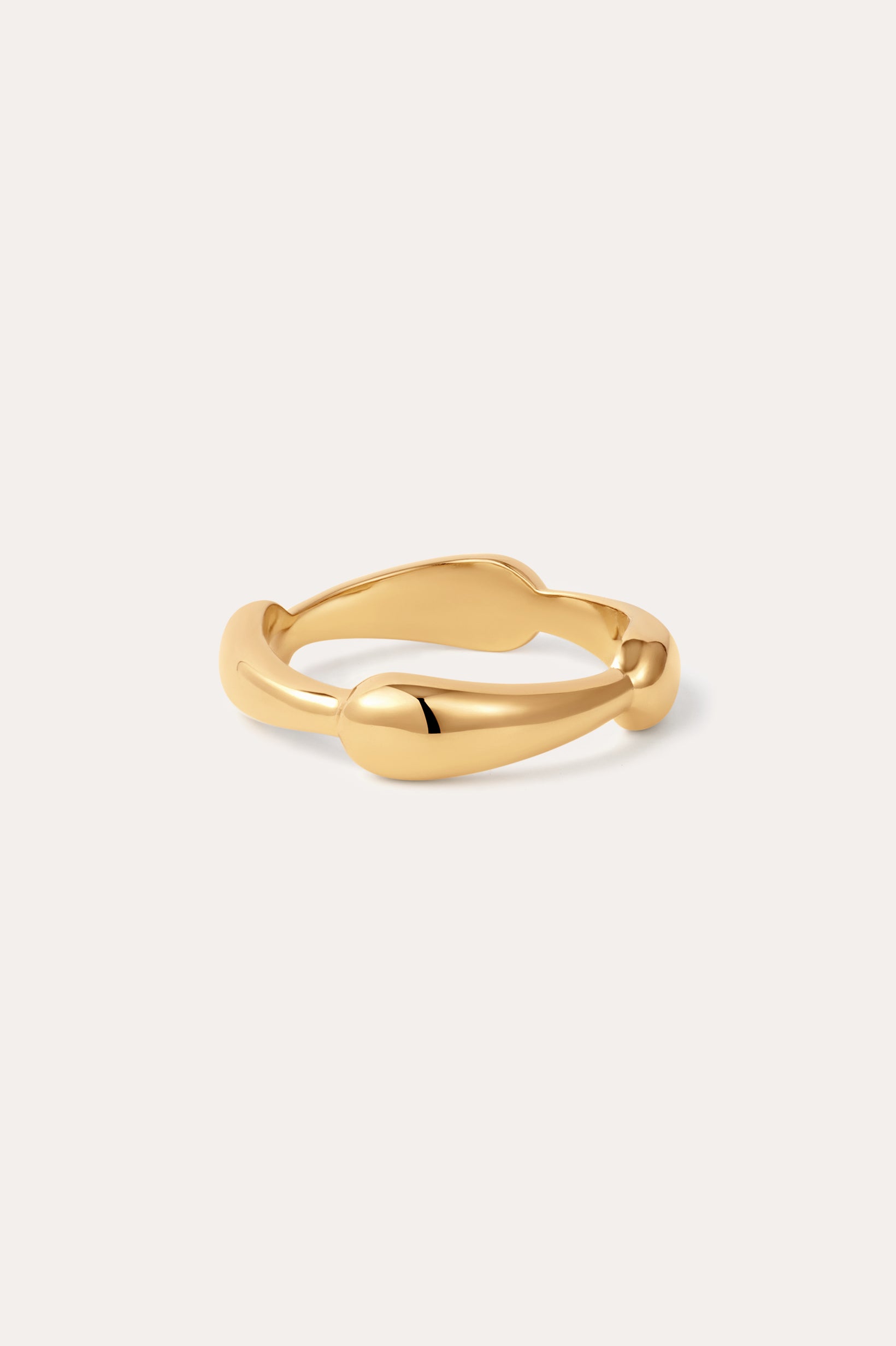 The Colette Link Droop Ring in Gold, featuring a wavy, organic design, is displayed against a simple, light background.