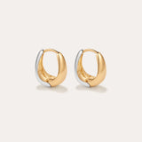 The Gia Reversible 2 Tone Chubby Hoop Earrings feature a smooth, rounded design in 18k gold and sterling silver, shown against a plain light background.