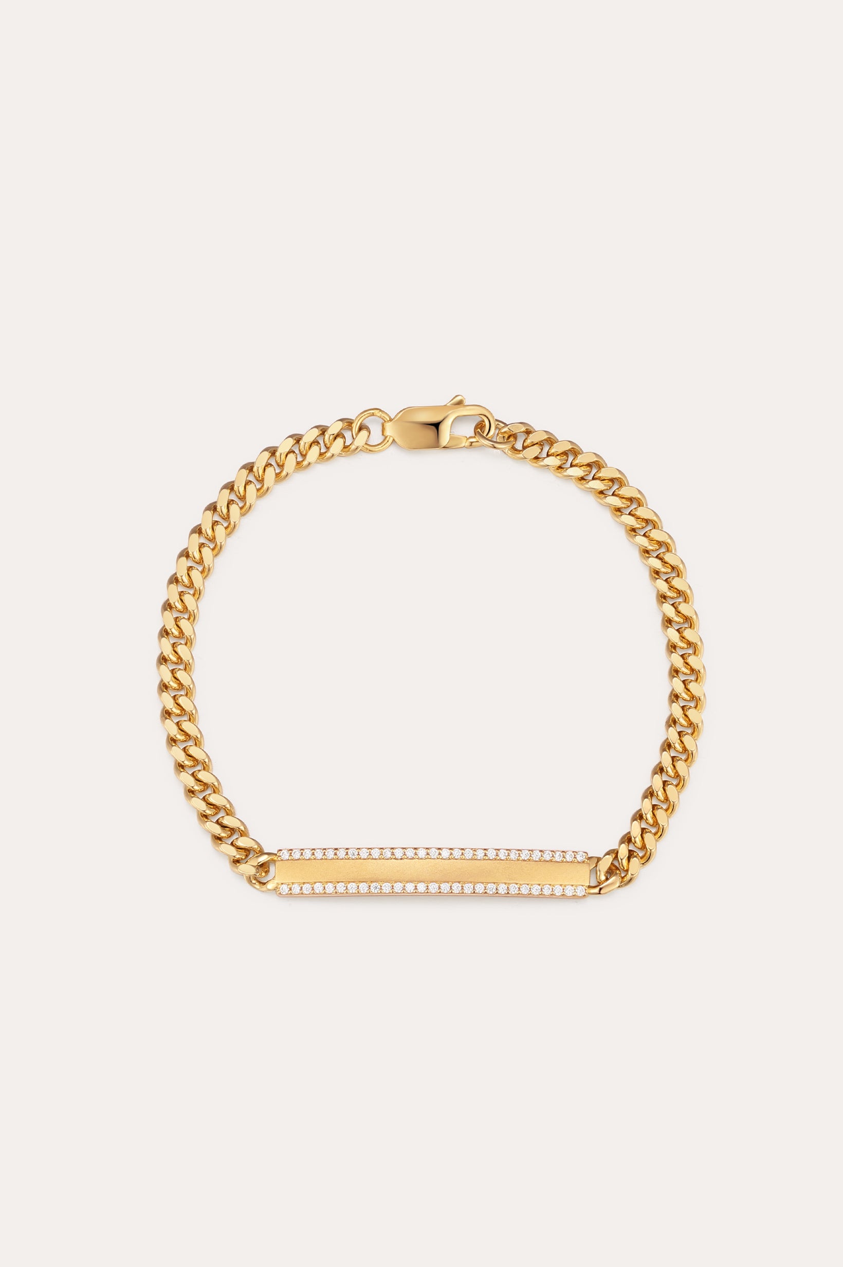 The Gisèle Cuban Link Bar Bracelet in Gold features a gold-plated chain, a lobster clasp, and a horizontal rectangular bar embellished with small sparkling clear stones.