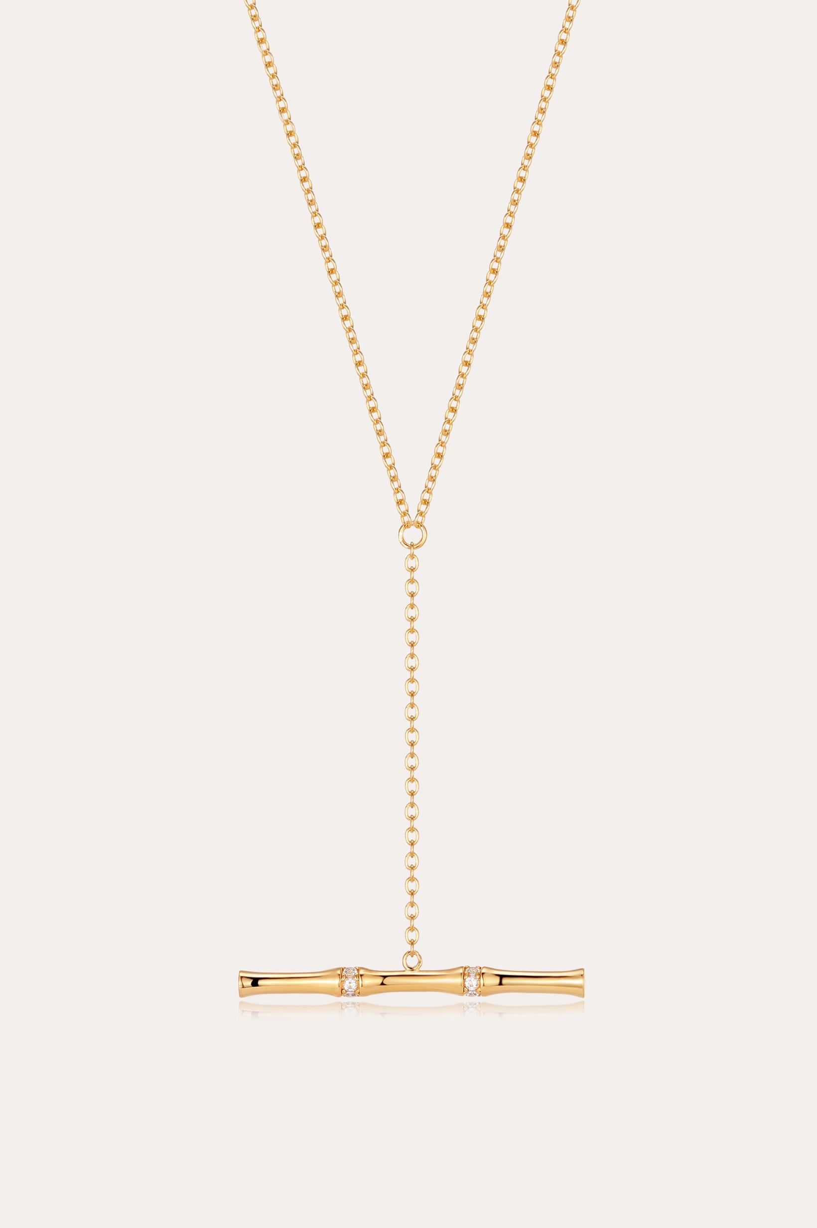 The Bamboo Chain Y-Bar Lariat Necklace in Gold features a delicate Y-shaped chain ending in a horizontal gold bar, accented with sparkling gemstones.