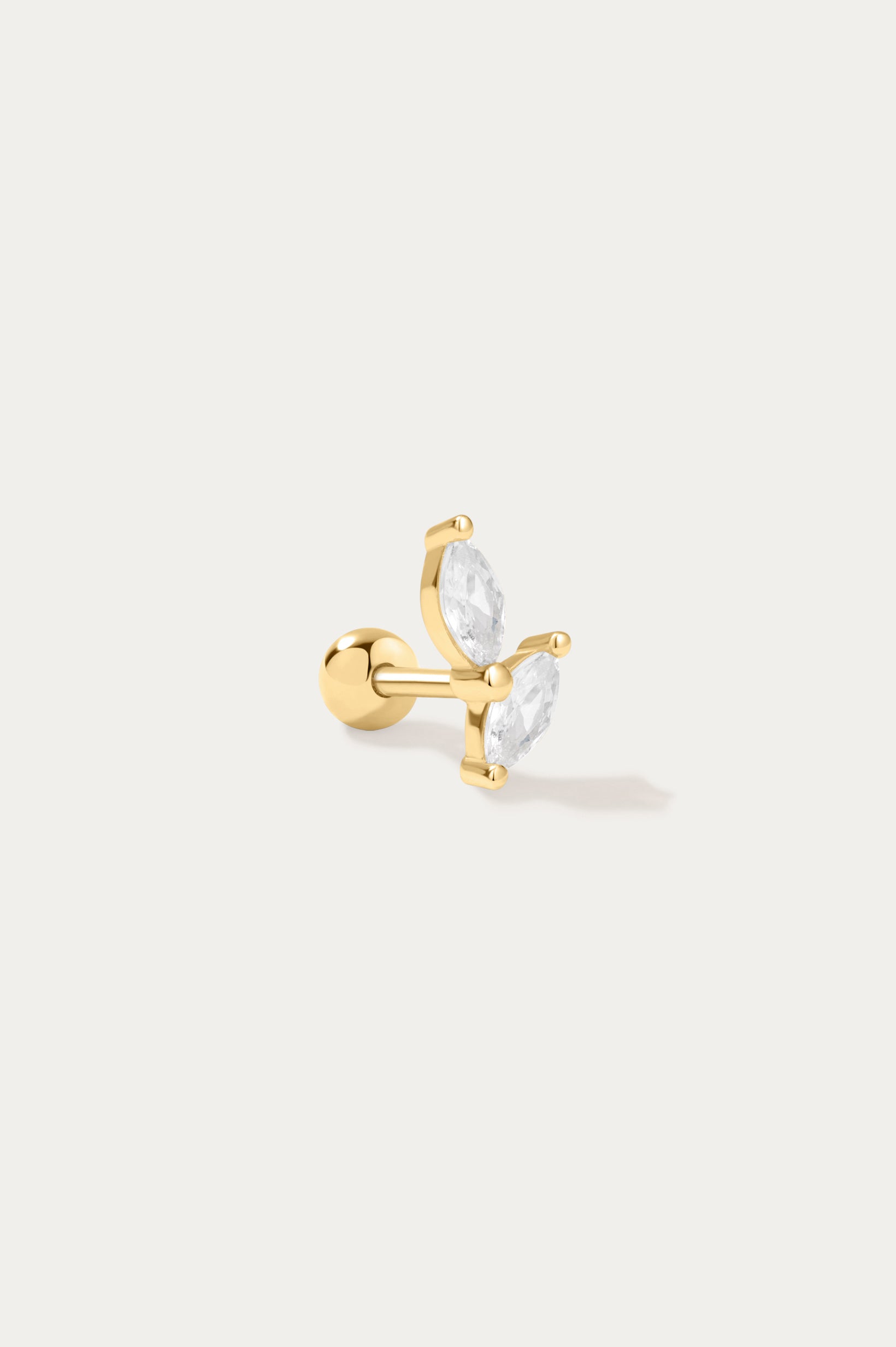 The Flora Barbell Stud in Gold is a butterfly-shaped earring with two clear marquise-cut cubic zirconia wings, shown on a plain white background.