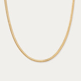 The Estelle Herringbone Chain Necklace in Gold is shown against a plain white background.