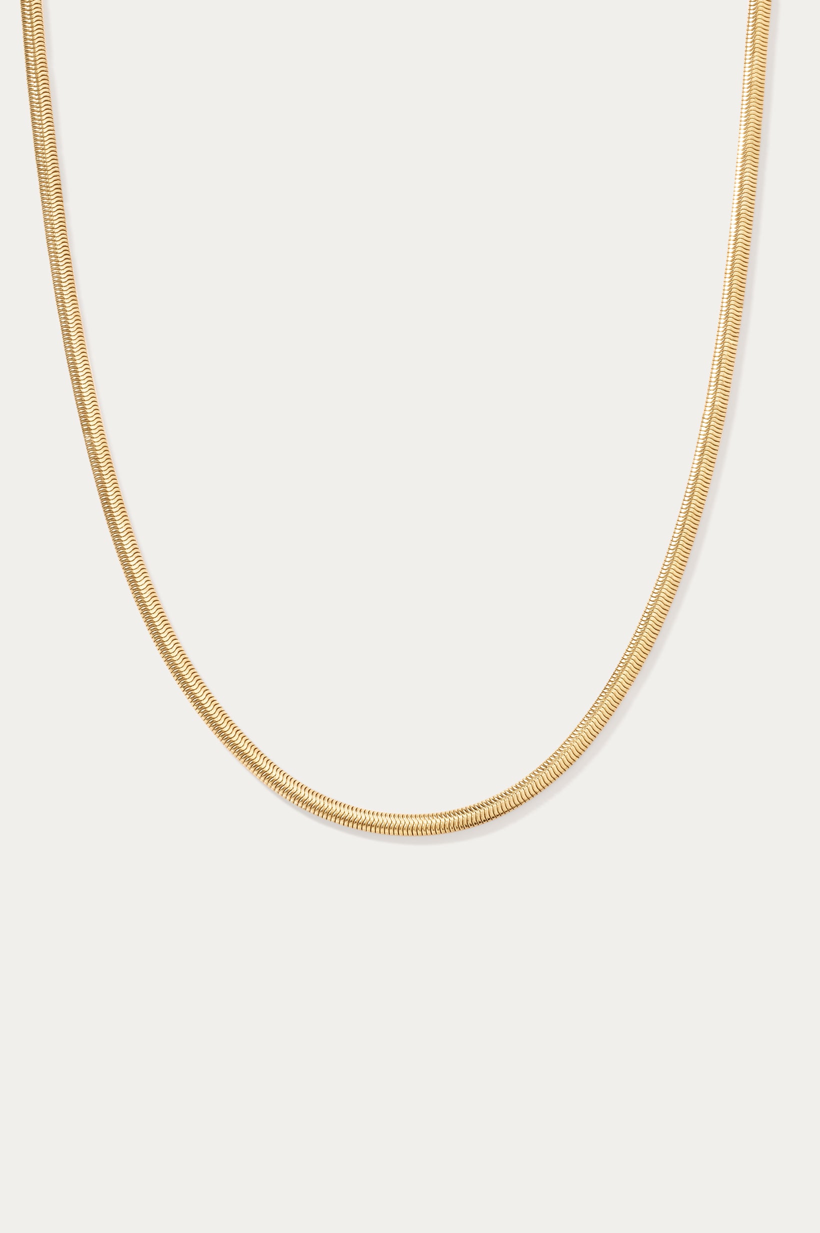 The Estelle Herringbone Chain Necklace in Gold is shown against a plain white background.