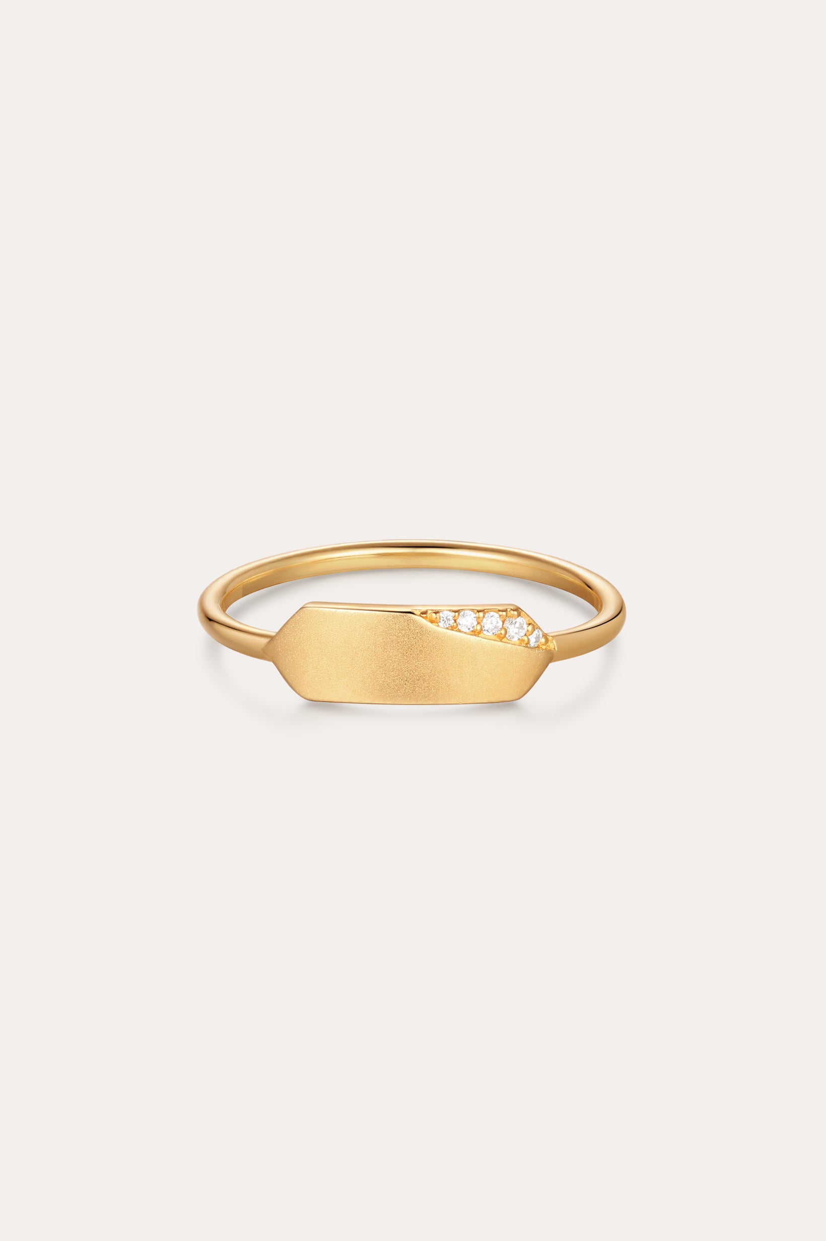 The Ines Horizontal Bar Ring in Gold features a flat, elongated plate adorned with a cluster of small sparkling diamonds on one side, shown against a plain white background.