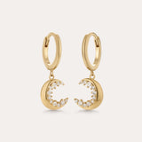 Crescent Moon Crystal Charm Huggies in Gold, featuring crescent moon charms with sparkling cubic zirconia, displayed on a plain light background.
