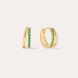 The Kira Crystal Double Hoop Huggies in Gold/Green are small earrings featuring a row of shimmering gemstones on the front, displayed against a plain light background.