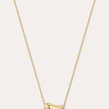 Gold necklace with a small pendant on a light gray background