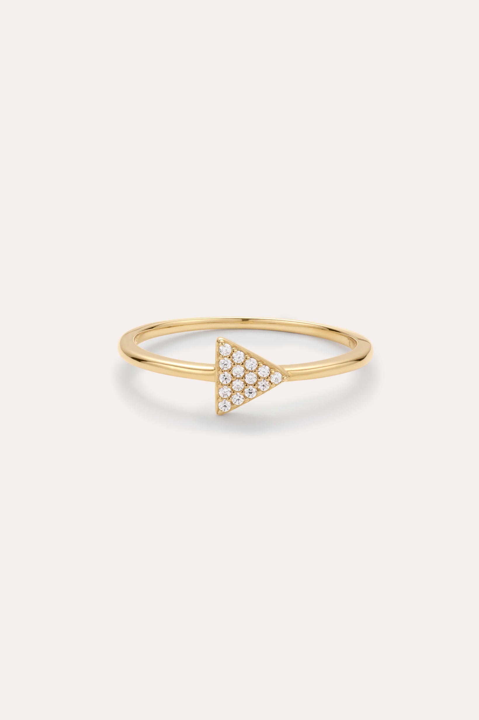 Gold ring with a triangle-shaped gemstone on a white background