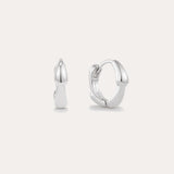 The Colette Droop Link Huggie Earrings in Silver are shown against a white background, with one earring facing front and the other from the side to display their sleek, polished, and minimalist design—ideal for everyday wear.