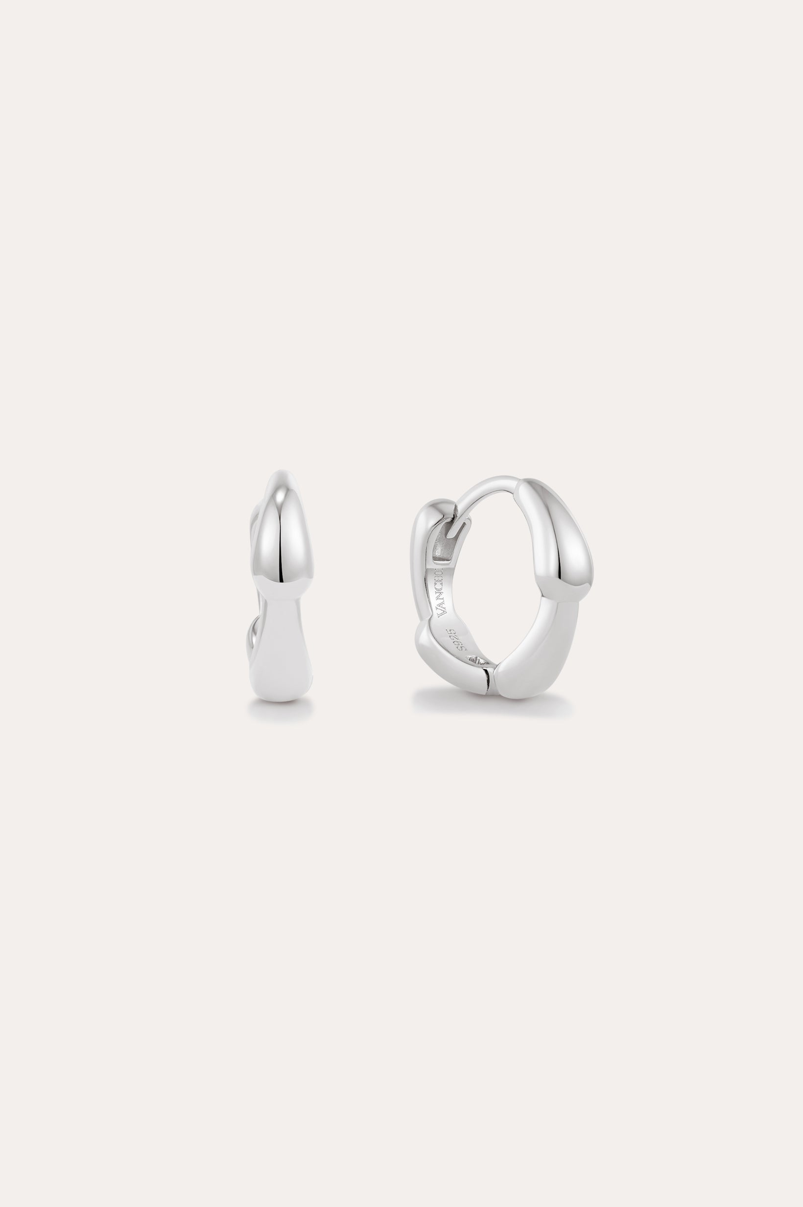 The Colette Droop Link Huggie Earrings in Silver are shown against a white background, with one earring facing front and the other from the side to display their sleek, polished, and minimalist design—ideal for everyday wear.