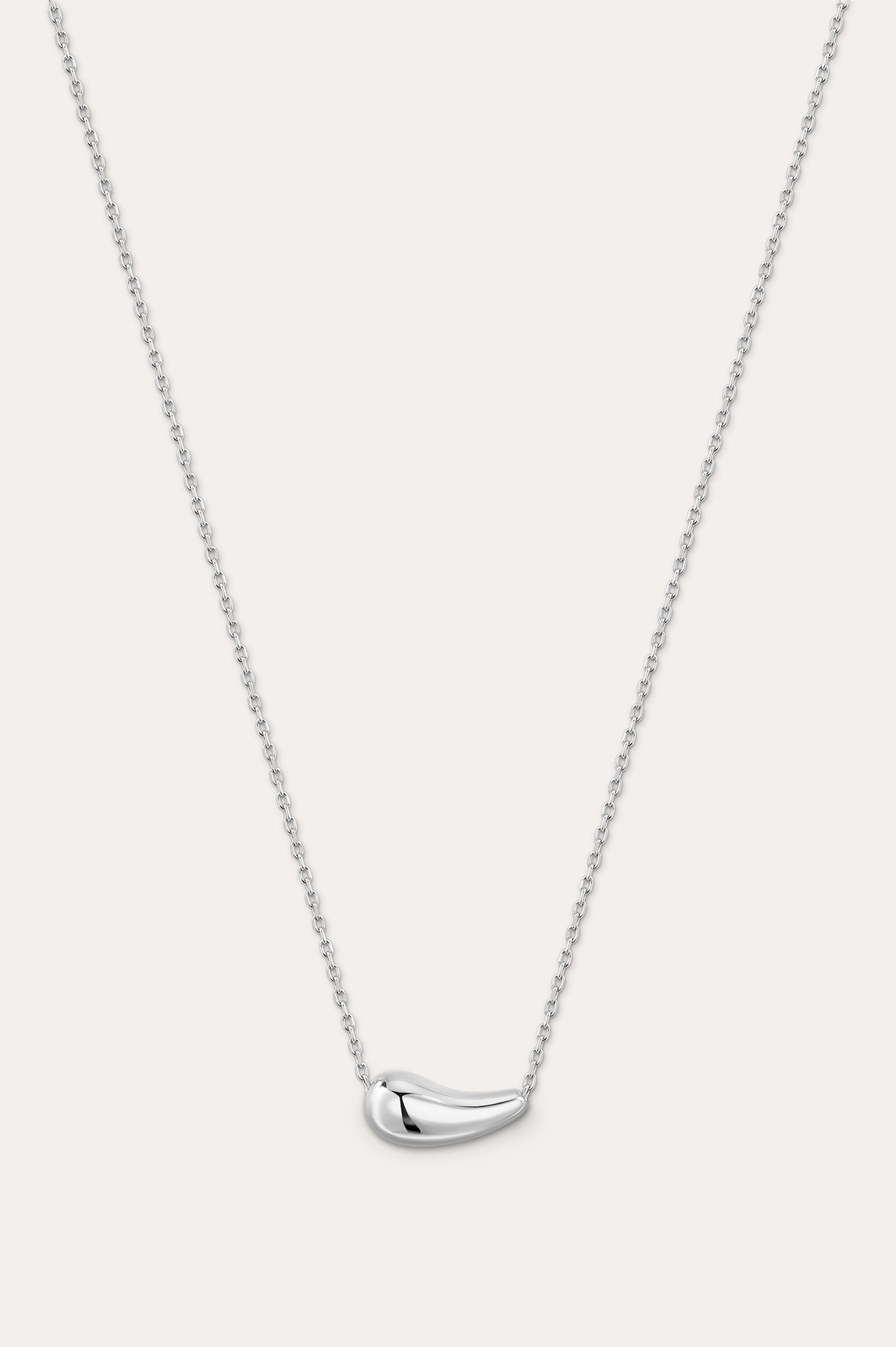 Silver necklace with a curved pendant on a light gray background