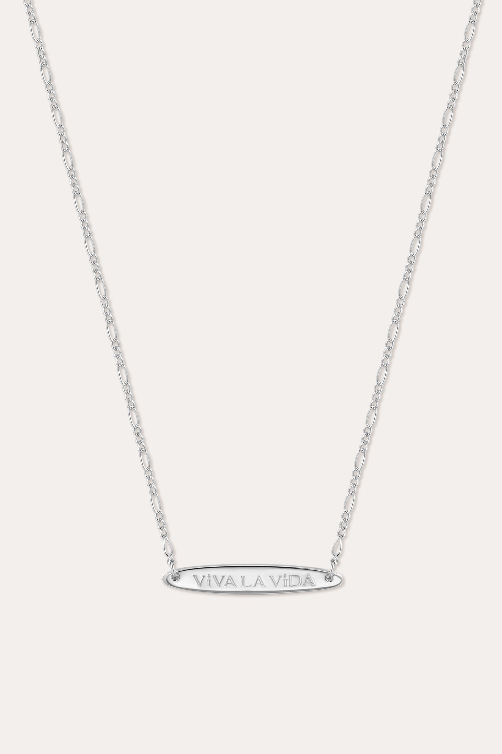 The Viva La Vida Bar Chain Necklace in Silver features a delicate, adjustable Figaro chain and an engraved oval horizontal bar pendant with VIVA LA VIDA in capitals, shown on a plain white background.