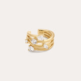 The Vale Crystal Ear Cuff in Gold features three parallel gold bands with clear gemstones and a “925” stamp inside, indicating sterling silver beneath the gold finish. Perfect for adding sparkle to your ear stack.