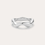 The Vica Fluid Wave Chunky Band Ring in Silver, featuring a smooth, wavy design, is displayed against a plain light background.