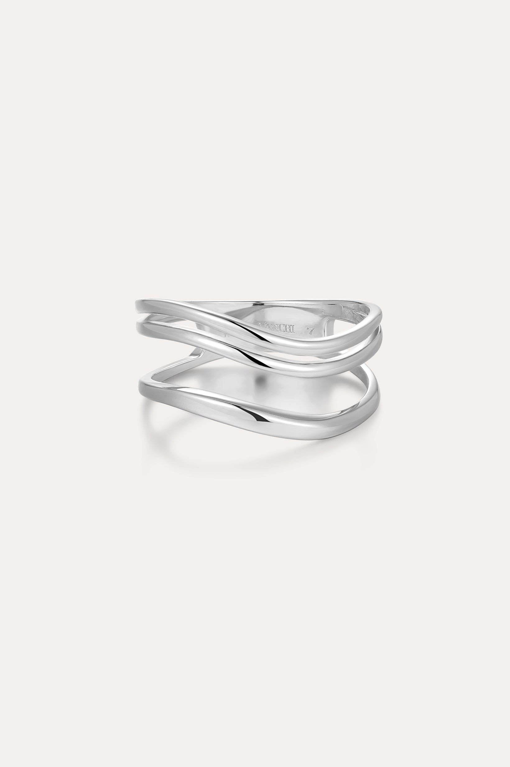 The Zoe Triple Wave Ring in Silver is a minimalist piece made from recycled sterling silver, featuring three polished, overlapping bands and shown against a plain light background.