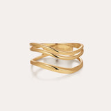 The Zoe Triple Wave Ring in Gold features three slim, wavy gold-plated bands intertwined for a modern, elegant look against a plain light background.