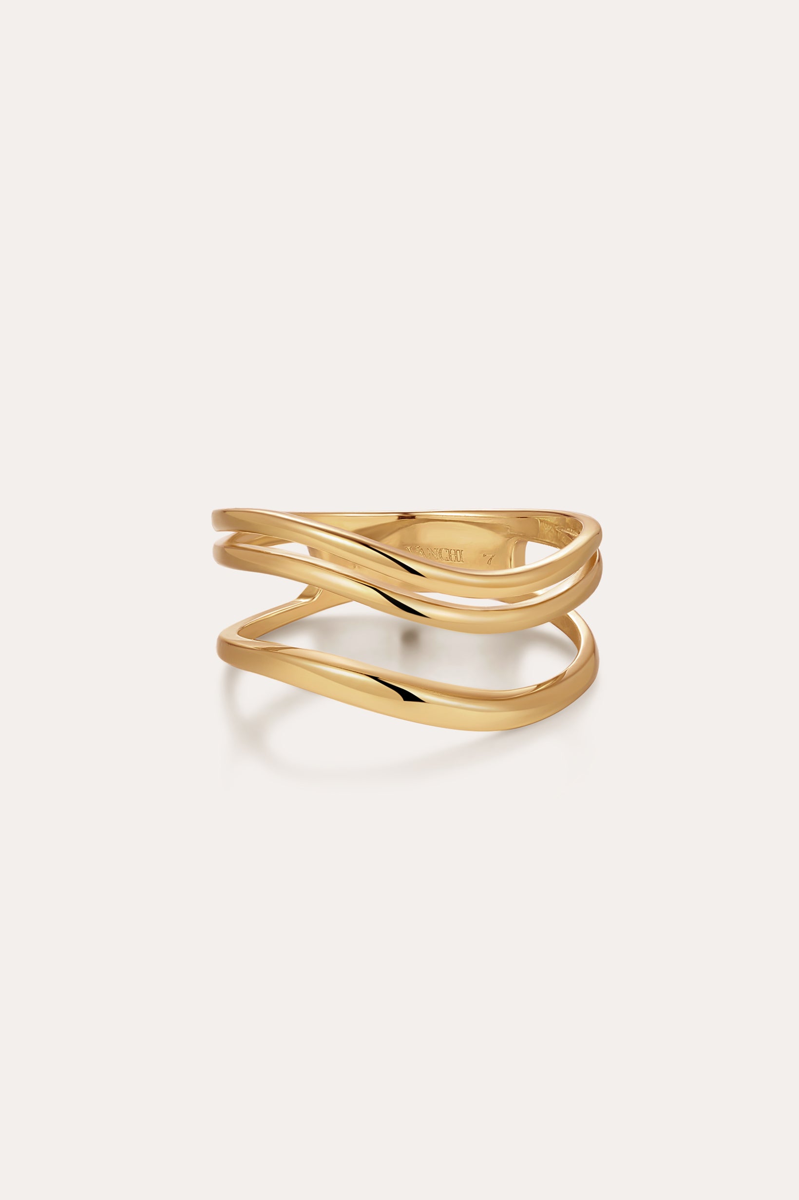 The Zoe Triple Wave Ring in Gold features three slim, wavy gold-plated bands intertwined for a modern, elegant look against a plain light background.