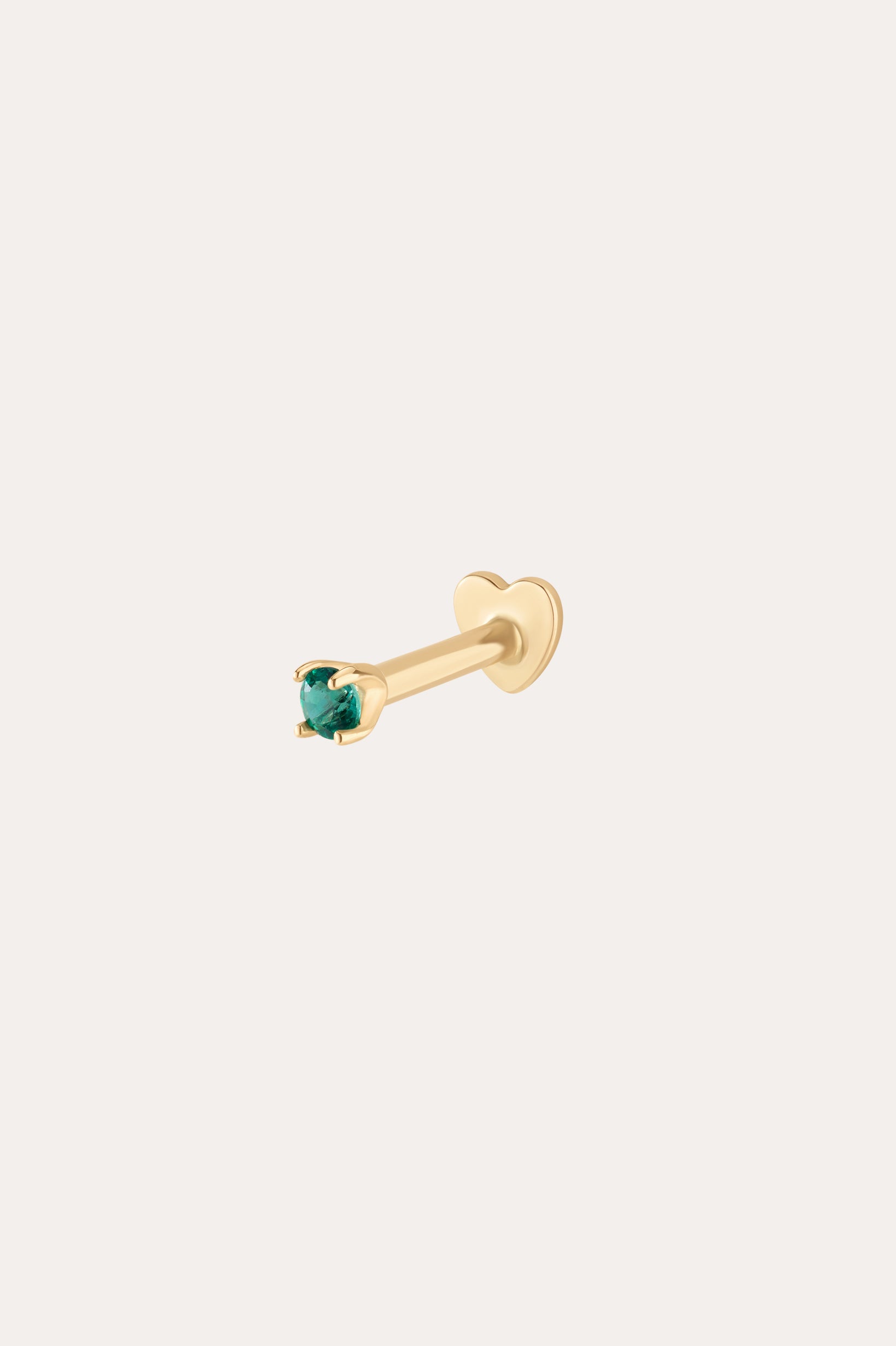 The 14K Solid Yellow Gold Green Emerald Flat Back Stud - 1.5mm features a small green emerald in a four-prong setting and heart-shaped back, shown on a white background. The color is 14K yellow gold with green emerald.