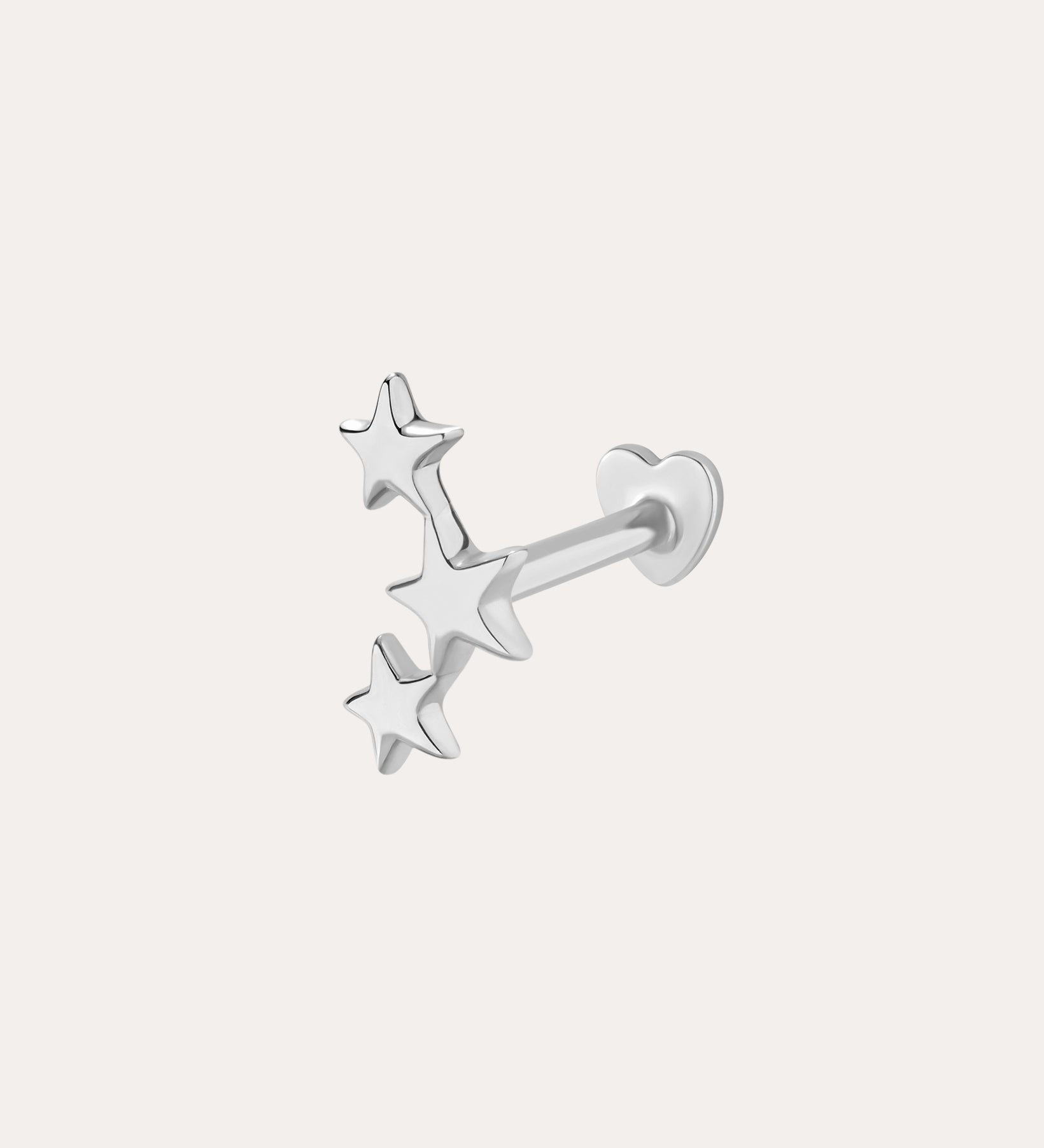 The 14K Solid White Gold Star Cluster Flat Back Stud features three stars in a vertical row and a heart-shaped backing, perfect for piercings. Shown against a plain light background.