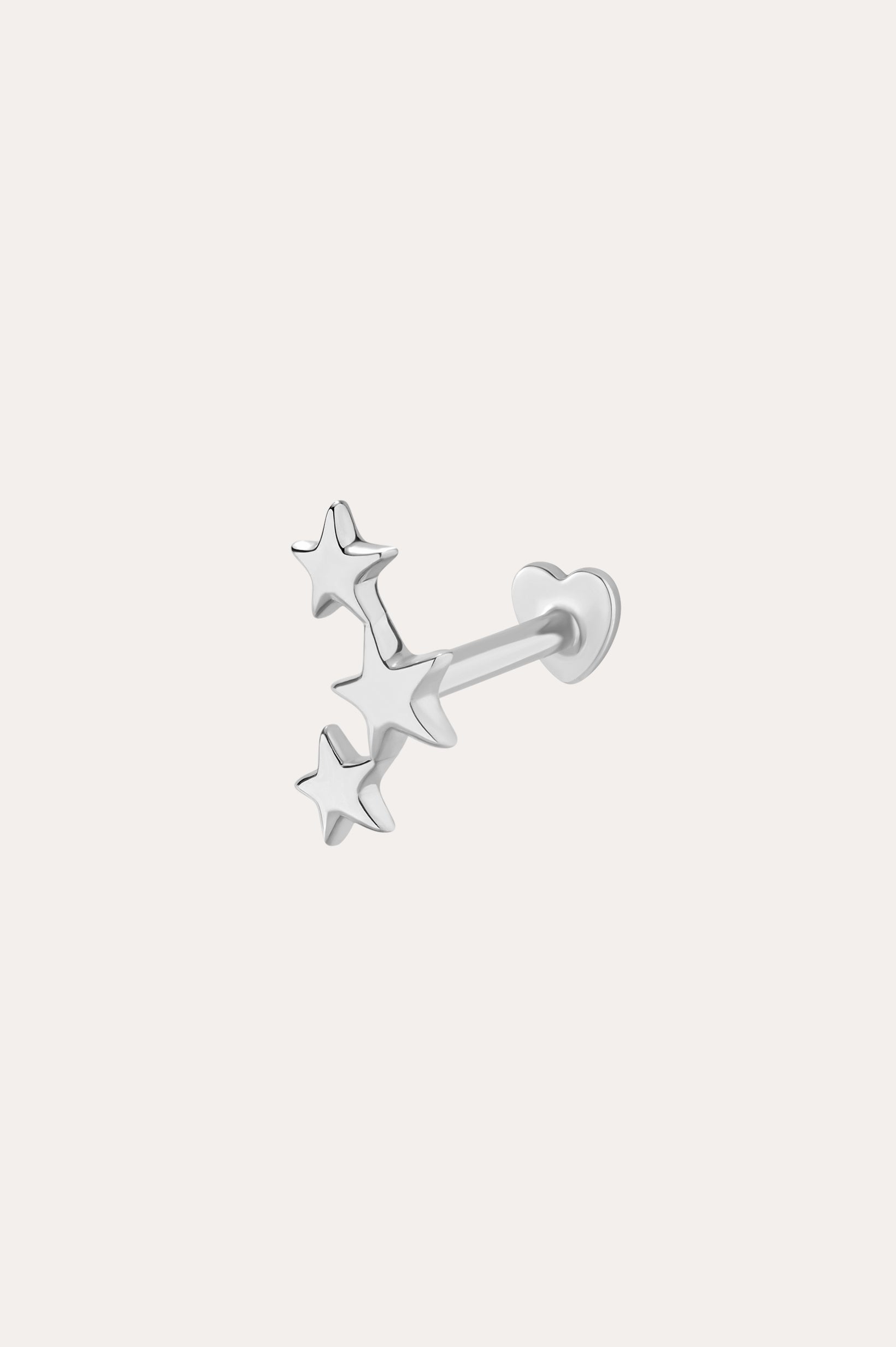 The 14K Solid White Gold Star Cluster Flat Back Stud features three stars in a vertical row and a heart-shaped backing, perfect for piercings. Shown against a plain light background.