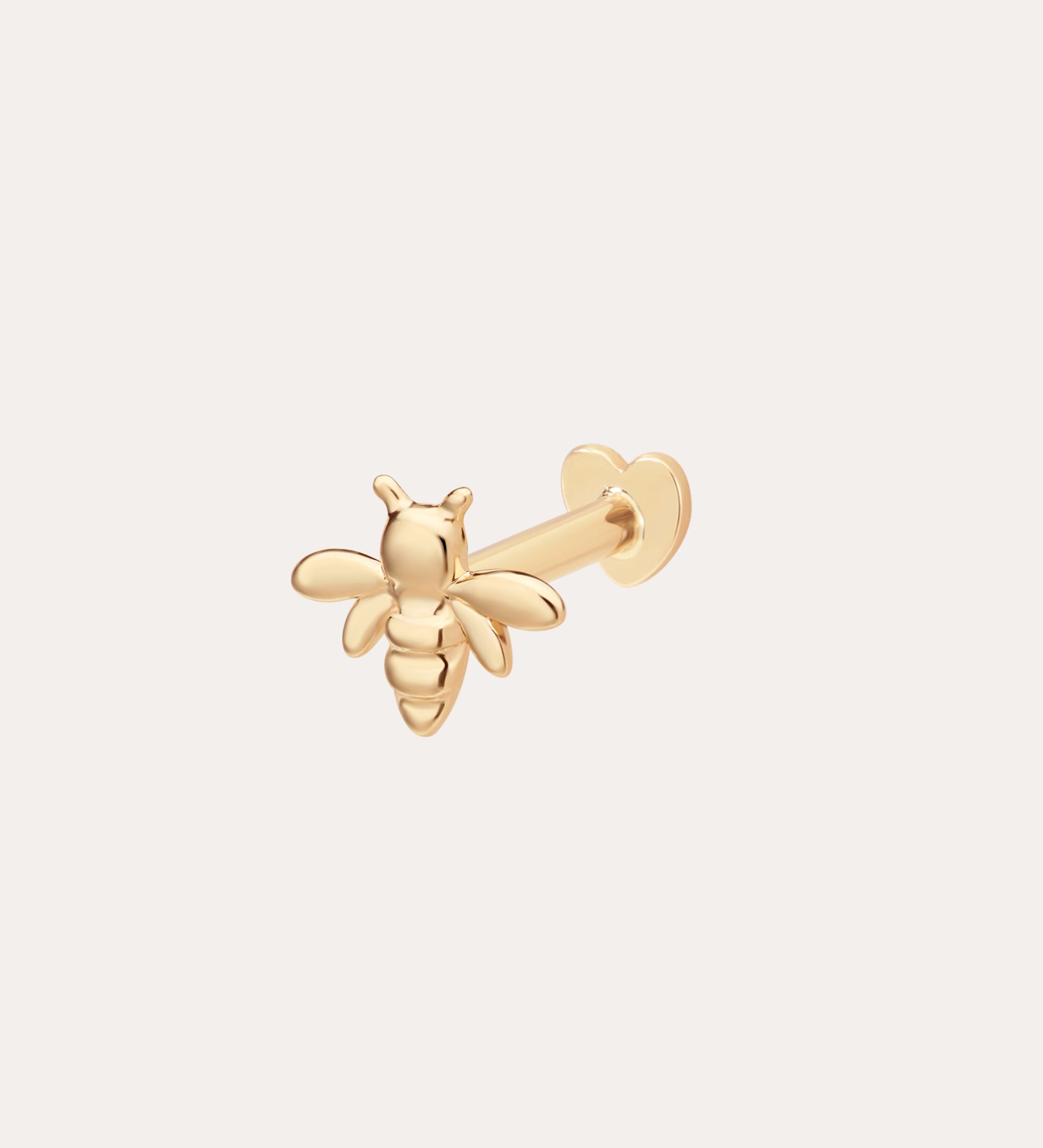 The 14K Solid Yellow Gold Busy Bee Flat Back Stud features detailed wings and body, a straight post, and a heart-shaped flat back, displayed on a plain light background.