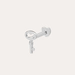 The 14K Solid White Gold Key Flat Back Stud, crafted in 14K white gold, is shown against a light background—ideal as a chic cartilage earring.