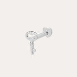 The 14K Solid White Gold Key Flat Back Stud, crafted in 14K white gold, is shown against a light background—ideal as a chic cartilage earring.