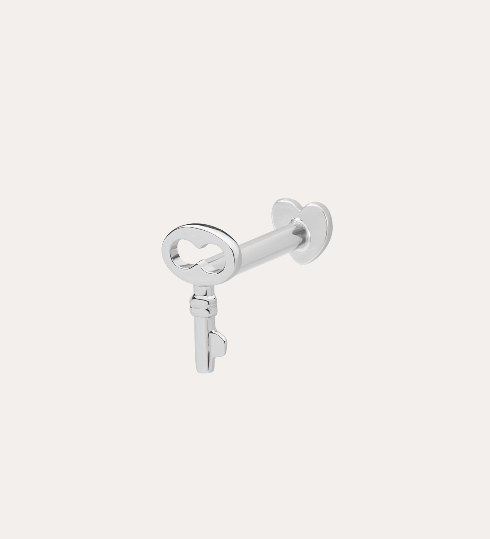 The 14K Solid White Gold Key Flat Back Stud, crafted in 14K white gold, is shown against a light background—ideal as a chic cartilage earring.
