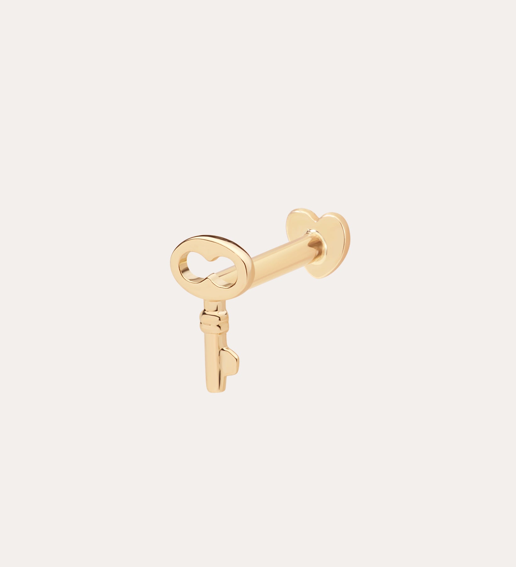 The 14K Solid Yellow Gold Key Flat Back Stud features a heart-shaped bow and is shown in 14K yellow gold against a simple, light background.