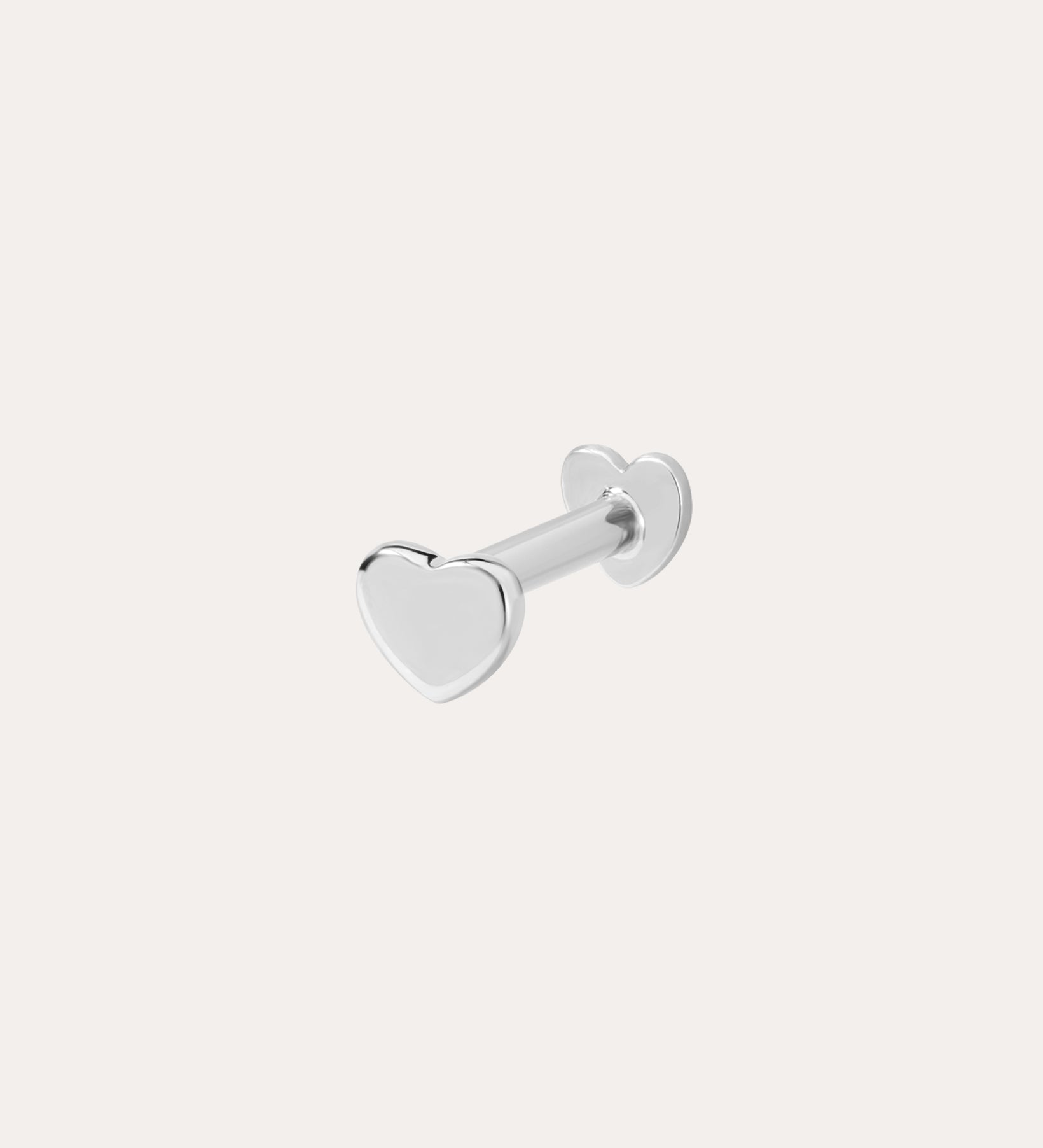 The 14K Solid White Gold Heart Flat Back Stud features a heart-shaped front and matching back, crafted in 14K white gold. Perfect as subtle body jewelry, its displayed on a plain white background.