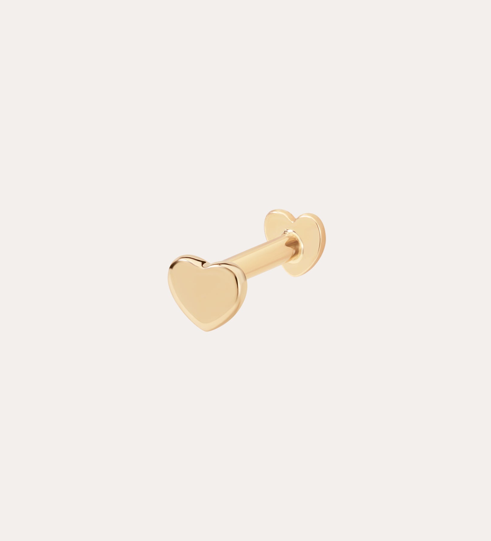 The 14K Solid Yellow Gold Heart Flat Back Stud features a heart-shaped front with matching backing, crafted from solid gold and displayed on a simple light background—ideal for those who love elegant body jewelry.