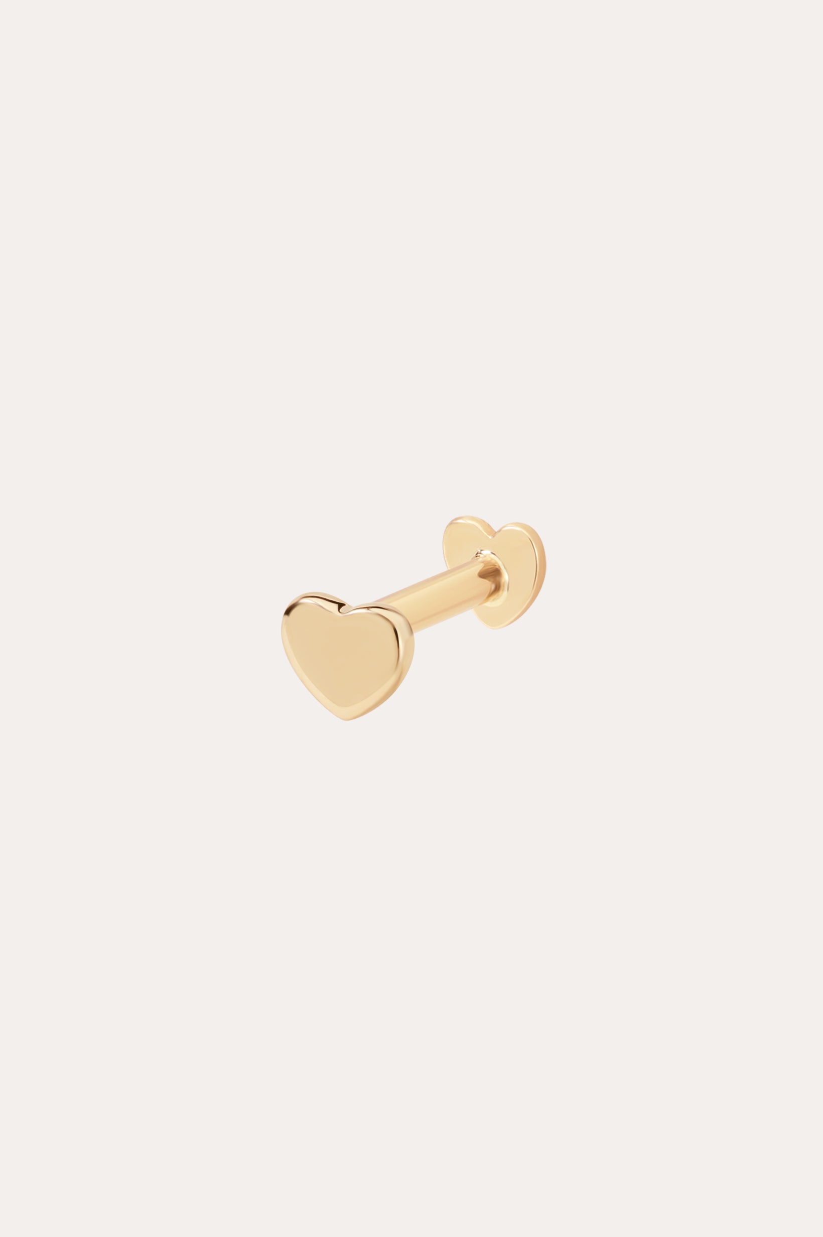 The 14K Solid Yellow Gold Heart Flat Back Stud features a heart-shaped front with matching backing, crafted from solid gold and displayed on a simple light background—ideal for those who love elegant body jewelry.