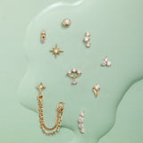 Collection of gold earrings on a green textured background