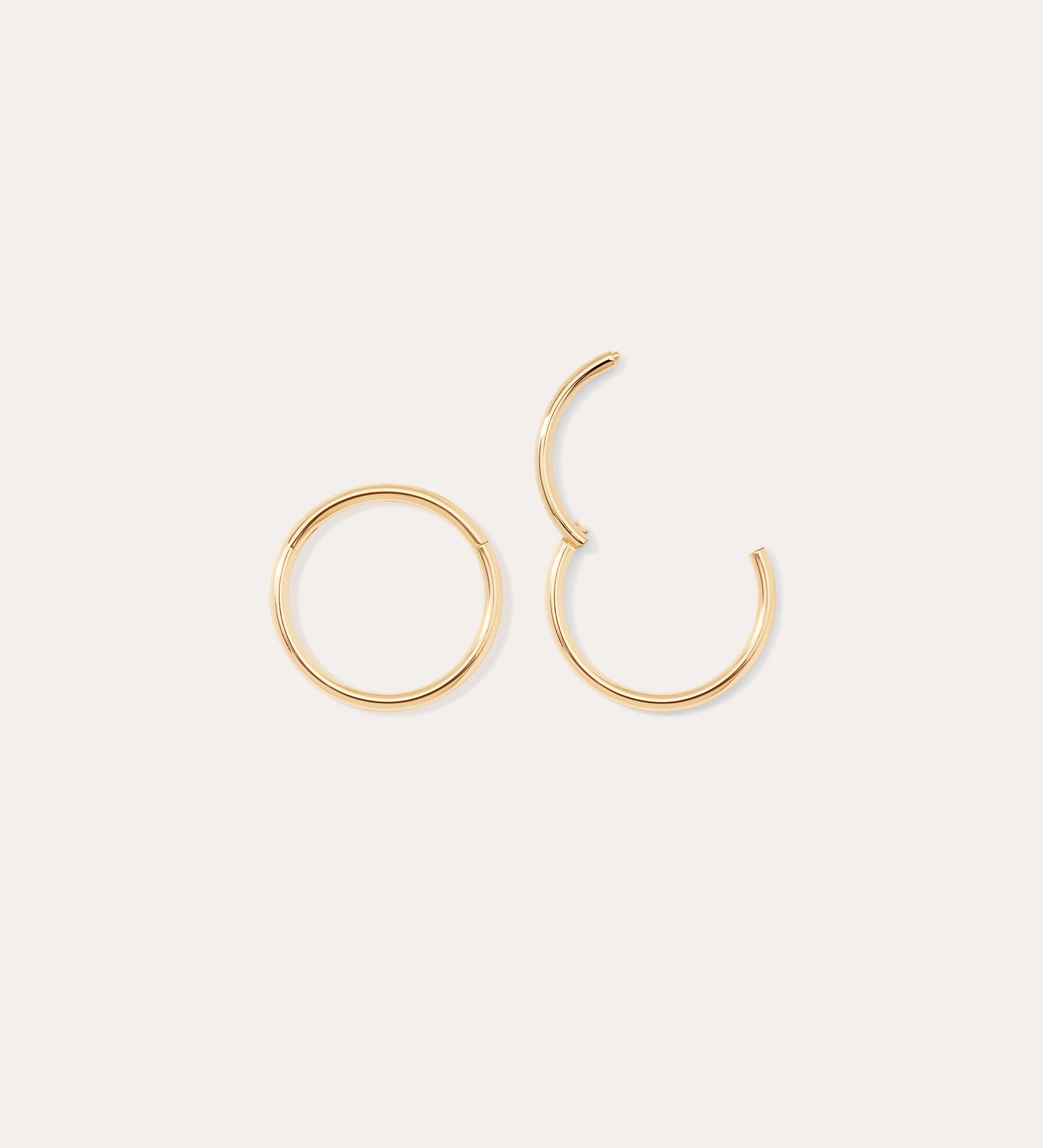 Two 14K Solid Yellow Gold 20G Mini Clicker hoop earrings are shown on a plain white background; one earring is fully closed and the other is partially open.