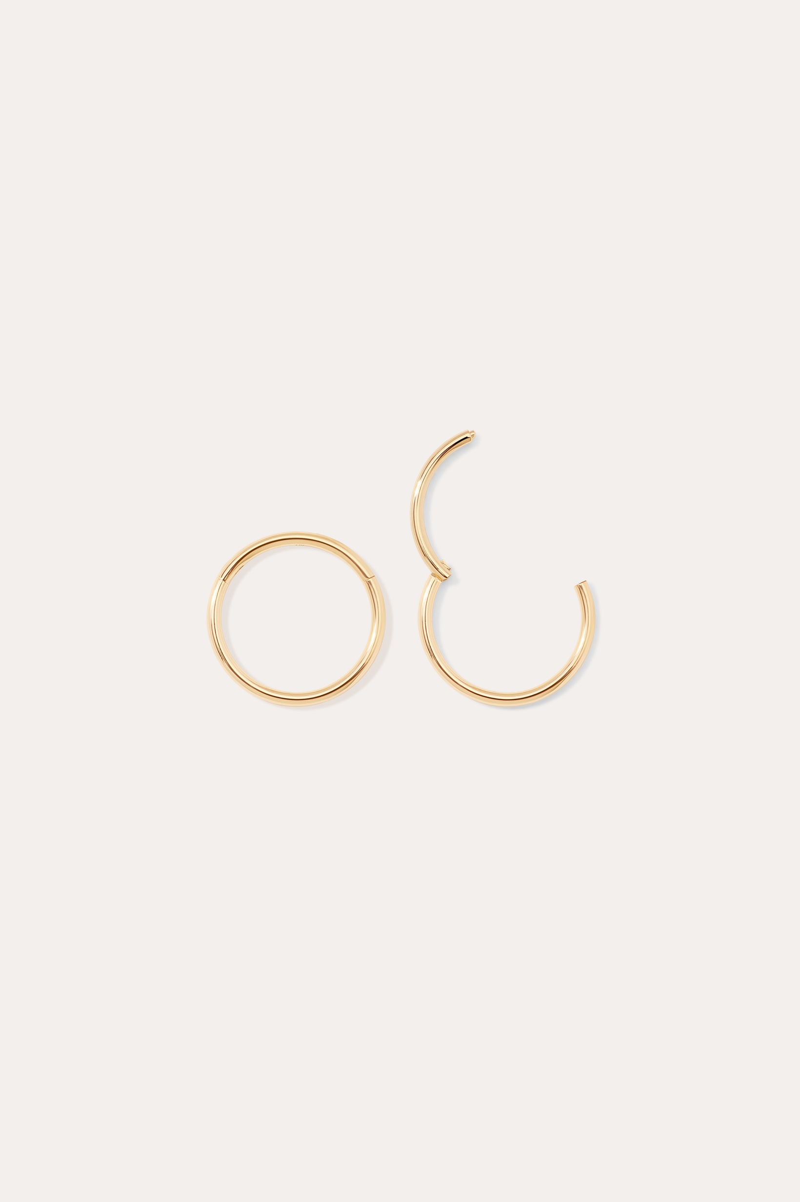 Two 14K Solid Yellow Gold 20G Mini Clicker hoop earrings are shown on a plain white background; one earring is fully closed and the other is partially open.