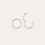 Two 14K Solid White Gold 20G Mini Clicker hoops are displayed on a plain white background—one closed, one slightly open—highlighting their simple, elegant circular design suitable for use as a nose ring or subtle ear accessory.