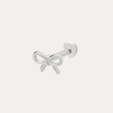 The 14K Solid White Gold Bow Tie Flat Back Stud, in 14K white gold, features a delicate bow front and heart-shaped flat back, shown on a plain white background.