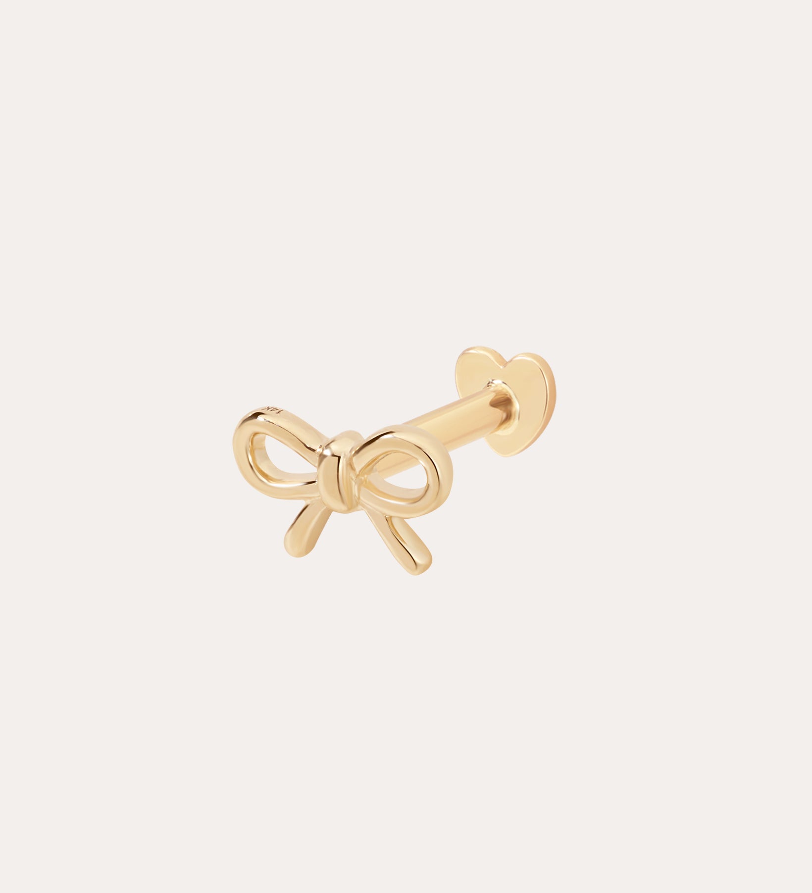 The 14K Solid Yellow Gold Bow Tie Flat Back Stud is a small earring with a heart-shaped flat back, elegantly displayed on a plain light background.