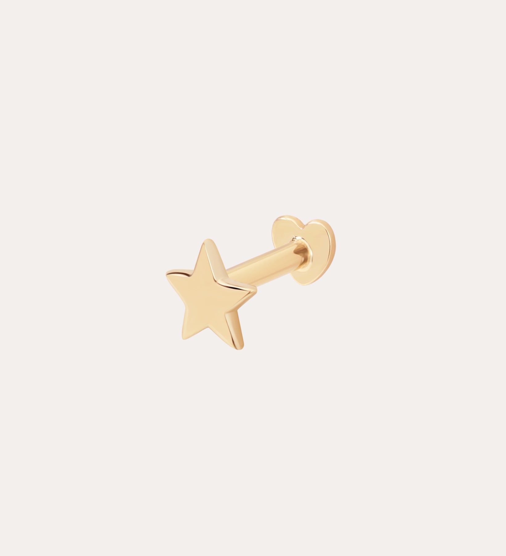 The 14K Solid Yellow Gold Star Flat Back Stud features a five-pointed star design in gleaming 14K yellow gold, making it a striking celestial ear accessory against any plain, light background.